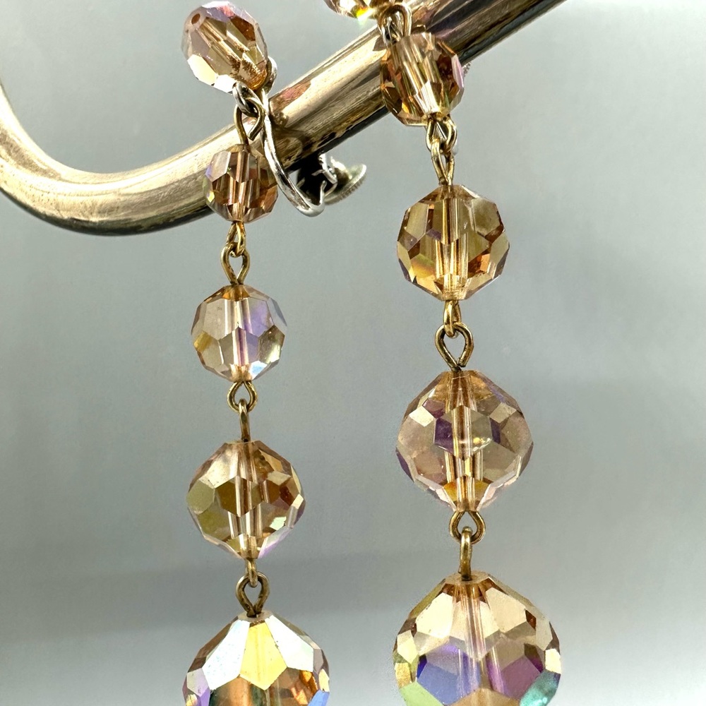 Crystal bead dangling earrings, gold/amber color. Spring screw back.